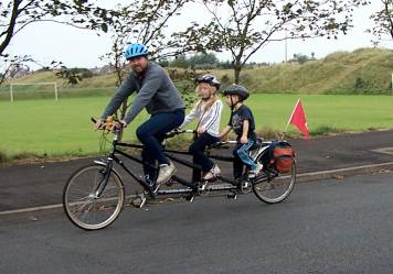 Family triplet bicycle in use